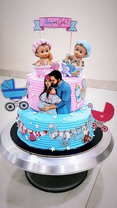 a baby shower cake with two people on top