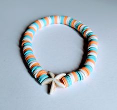 A sealife mix of white, orange and blue clay beads on elasticated thread with a starfish bead. To fit a 20cm wrist but can be made larger on request. Orange Clay Bead Bracelets, Beach Bracelets Clay Beads, Hibiscus Jewelry, Polymer Clay Bead Bracelet, Aesthetic Bracelets, Beaded Starfish