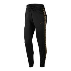 the nike pant is shown in black with gold lettering on the bottom and side