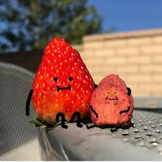 two strawberries sitting next to each other with faces drawn on them and the caption visiting grandma