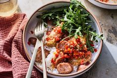 two plates of food with meat, rice and vegetables next to a glass of beer