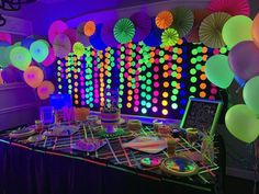 an image of a party setting with neon lights and paper umbrellas on the wall