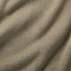 a close up view of the texture of a fabric material, in light brown tones