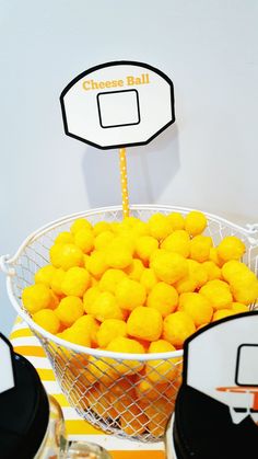 a bowl filled with oranges sitting on top of a table next to other items