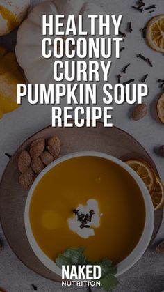 healthy coconut curry pumpkin soup recipe on a plate with nuts and oranges around it