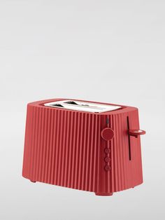 a red toaster sitting on top of a white table