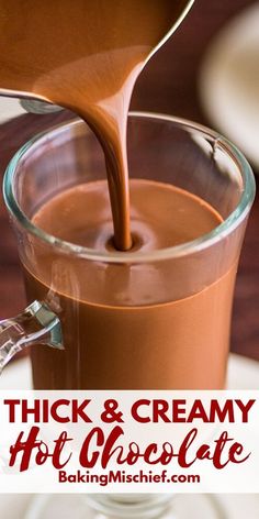 thick and creamy hot chocolate being poured into a glass mug