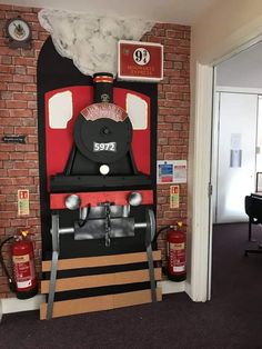 a red and black machine sitting in front of a brick wall