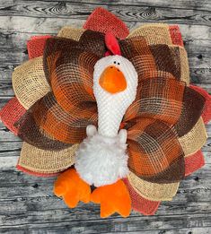 a stuffed turkey sitting on top of a wooden table