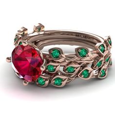 a set of three rings with green and red stones on each ring, in gold plated