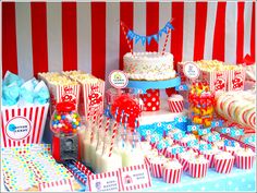 a table topped with lots of cakes and cupcakes