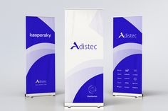 two roll up banners with blue and white designs on the front, one for asistec