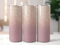 three pink and gold glitter tumblers sitting on top of a table