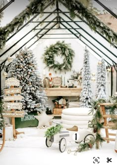 a christmas display in a room with trees and decorations on the walls, along with an old fashioned toy car