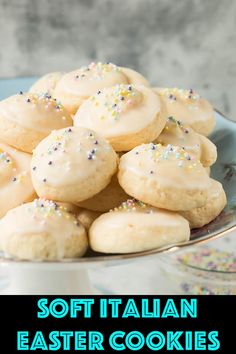 a plate full of cookies with white frosting and sprinkles