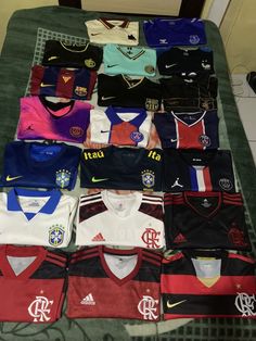 a table topped with lots of different soccer jerseys