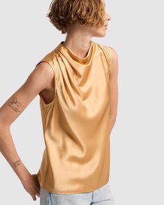 Fits like: Sleeveless shirt with draped neckline and relaxed fit. Feels like: Light and silky. The Details: 100% Silk Warm gold shade Chic Gold Sleeveless Top, Summer Silk Draped Top, Elegant Drapey Sleeveless Top, Chic Gold Satin Top, Gold Sleeveless Blouse For Spring, Gold Silk Blouse For Summer, Gold Silk Evening Top, Gold Silk Top For Evening, Spring Gold Silk Top