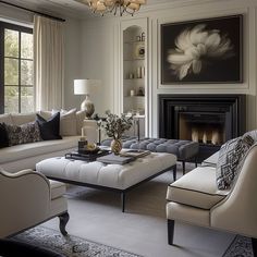 a living room filled with furniture and a fire place in front of a painting on the wall