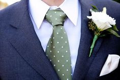 a man in a suit and tie with a boutonniere on his lapel