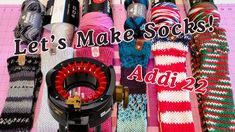 there are many knitted items on the table with words that say let's make socks