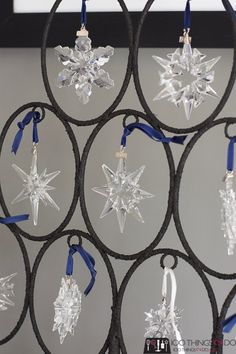 an ornament is hanging on the wall in front of some circular rings with snowflakes