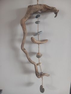 a driftwood wind chime hanging on the wall