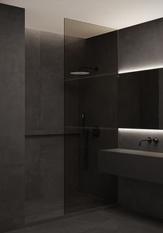 a black and white photo of a bathroom with a sink, mirror and shower head