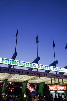 the minnesota state fair entrance is lit up at night