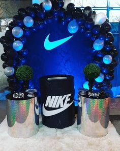 the nike display is decorated with balloons and tin canisters as well as decorations