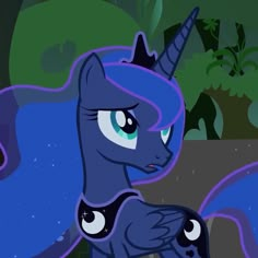 the blue pony is standing in front of some trees and bushes, with its eyes closed