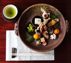 a brown plate topped with different types of sushi