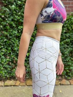 a woman in a sports bra top and patterned leggings