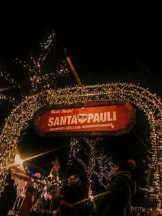 the entrance to santa pauli is lit up with christmas lights and garlands on it