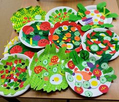 paper plates with different designs on them are sitting on a table in the shape of flowers and leaves