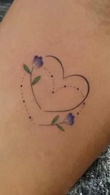 a small heart tattoo with flowers on it