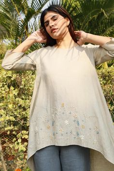 Beige asymmetric tunic with placement floral embroidered motifs.
Component: 1
Embroidered
Neckine: Round
Sleeve Length: Three quarter
Fabric: 100% Linen
Color: Beige
Note: Pant worn by the model is not for sale - Aza Fashions Festive Summer Kurta With Embroidered Hem, Summer Straight Kurta With Embroidered Hem, Spring Wedding Tops With Embroidered Neckline, Elegant Spring Tunic With Embroidered Neckline, Summer Floral Embroidered Straight Kurta Top, Floral Embroidered Straight Kurta Top For Summer, Spring Wedding Straight Kurta Top, Spring Tunic Kurta With Embroidered Neckline, Spring Floral Embroidered Straight Kurta Top