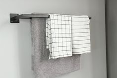 two towels are hanging on a towel rack