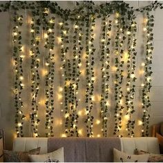 a living room filled with lots of lights and greenery hanging on the side of the wall