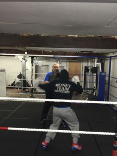 two men in a boxing ring practicing their moves