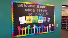 a bulletin board with children's handprints on it in a school library