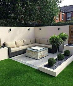 an outdoor living area with grass and plants