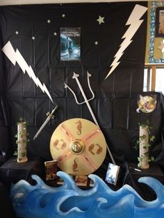 a display with various items on it in front of a black wall and blue waves