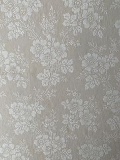 the wall paper has white flowers on it