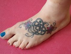 a woman's foot with a tattoo on it