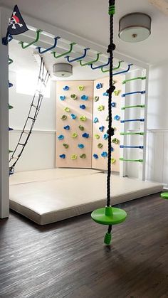 an empty room with climbing ropes and swings