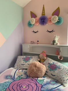 there is a stuffed animal that is laying on the bed in front of the wall