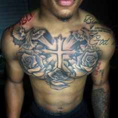 a man with a cross and roses tattoo on his chest