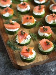 cucumbers with smoked salmon and capers on them are ready to be served