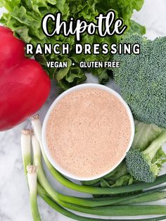 a bowl of ranch dressing surrounded by fresh vegetables