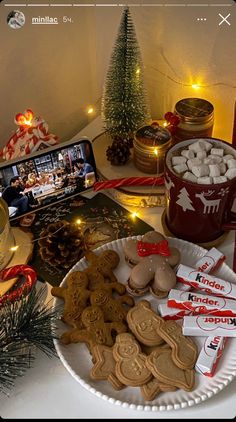 a table topped with lots of different types of cookies and other food on top of a white plate